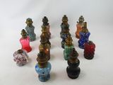 a lot of different colored vases sitting on a white surface