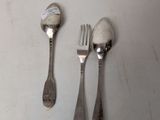three forks and two spoons sitting on a table
