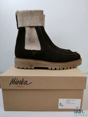 the box has a pair of black boots on top of it