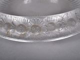 a glass bowl with flowers on it on a table