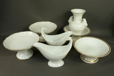 a group of white and gold china dishes and bowls