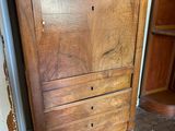 a wooden cabinet that has a basket on top of it