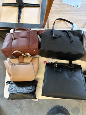 many bags that are sitting on a table
