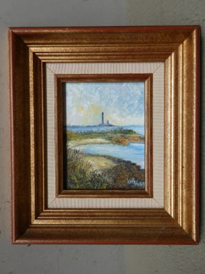 peinture à l'huile encadrée représentant un phare sur une plage au bord d'un plan d'eau