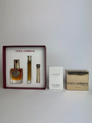 three different perfumes in a box on a table