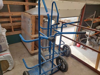 a blue hand truck that is sitting in a garage
