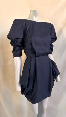 the mannequin is wearing a black dress with ruffled sleeves