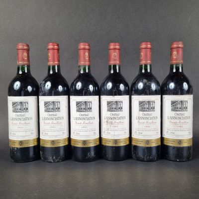 six bottles of wine are lined up in a row on a table