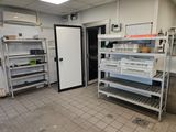 an image of a kitchen with a refrigerator and shelves