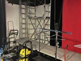 a room with scaffolding on the walls and a chair