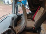 a seat in the back of a truck with a broken steering wheel