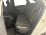 the back seats of a white car with a black seat belt