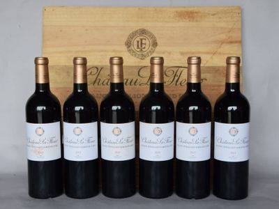 six bouteilles de vin rouge sont alignées devant une caisse en bois