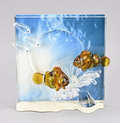 two glass figurines of two fish in the water