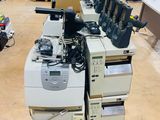 many electronic equipment sitting on a pallet in a warehouse