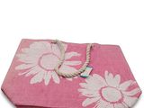a pink towel with white flowers on it on a white background