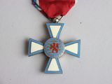 a medal with a cross on it on a table