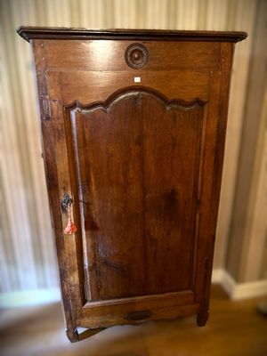 a wooden cabinet with a door on the top of it