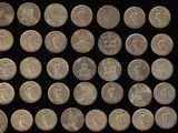 a lot of coins that are on a black surface