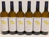 six bottles of wine are lined up on a table
