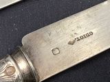 a knife that is sitting on a table next to a knife