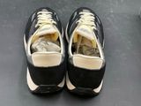 a pair of black and white sneakers on a table