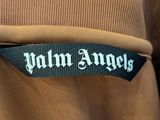 a close up of a brown jacket with a palm angels logo on it