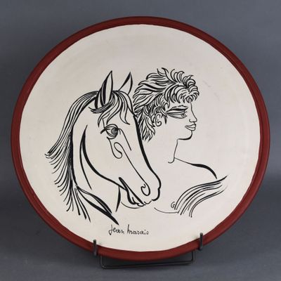 a plate with a drawing of a woman and a horse on it