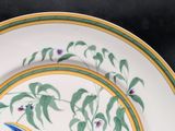 a plate with a bird painted on it and a plate with a bird painted on it