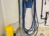 a blue hose and a yellow can on the floor