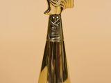 a gold trophy with a bird on top of it