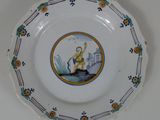 a plate with a picture of a man riding a horse on it