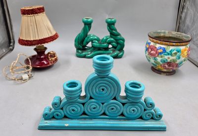 trois vases de couleurs différentes et une lampe posés sur une table