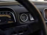a close up of a dashboard with a speedometer and gauges