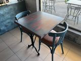 a table and two chairs in front of a window