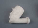 a small statue of a man with a hat and a pipe