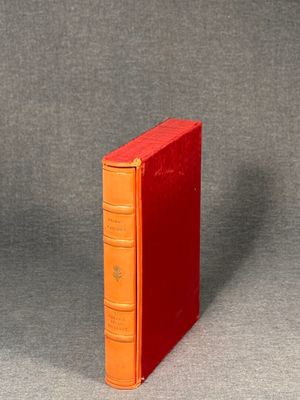 an orange book sitting on top of a gray surface
