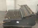 an old typewriter sitting on the floor in a room