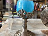 a blue candle that is sitting on a wooden table
