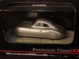 a silver model car in a black box on a table