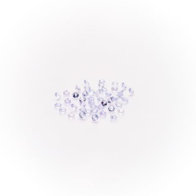 a close up of a pile of clear crystals on a white surface