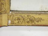 a mirror that has a gold frame on it