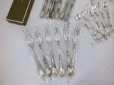 a lot of forks and spoons that are wrapped in plastic