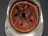 a metal bowl with a red flower inside of it