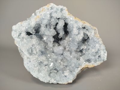a close up of a large piece of crystal on a gray surface