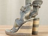 an image of a pair of women ' s sandals on a wooden table