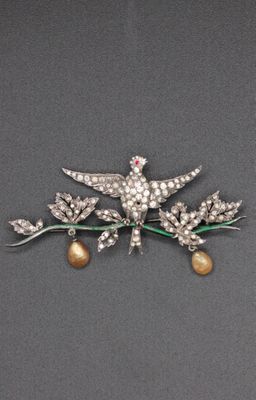 Ch. Dior. Brooch depicting a bird of Liberty resting on a Ch. Dior. Brooch depicting a bird of Liberty resting on a