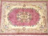 rug on the floor is pink and white with a floral design