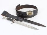 a knife and a belt on a white surface