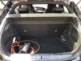 the trunk of a car with a bunch of wires in it